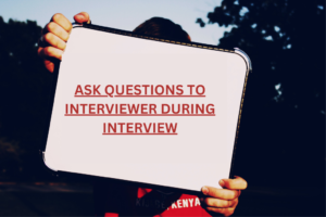 Man holding white board with Questions to Ask Interviewer During Interview