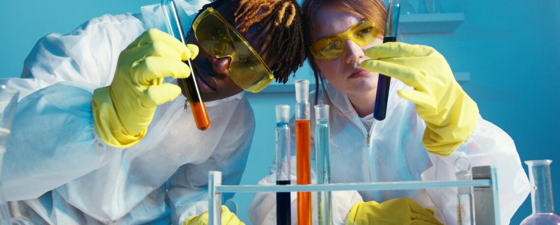 a man and a woman medical assistant after clearing interview questions holding a test tube